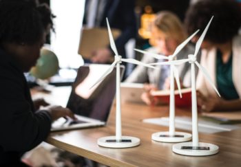 Models of wind turbines sit on an office desk