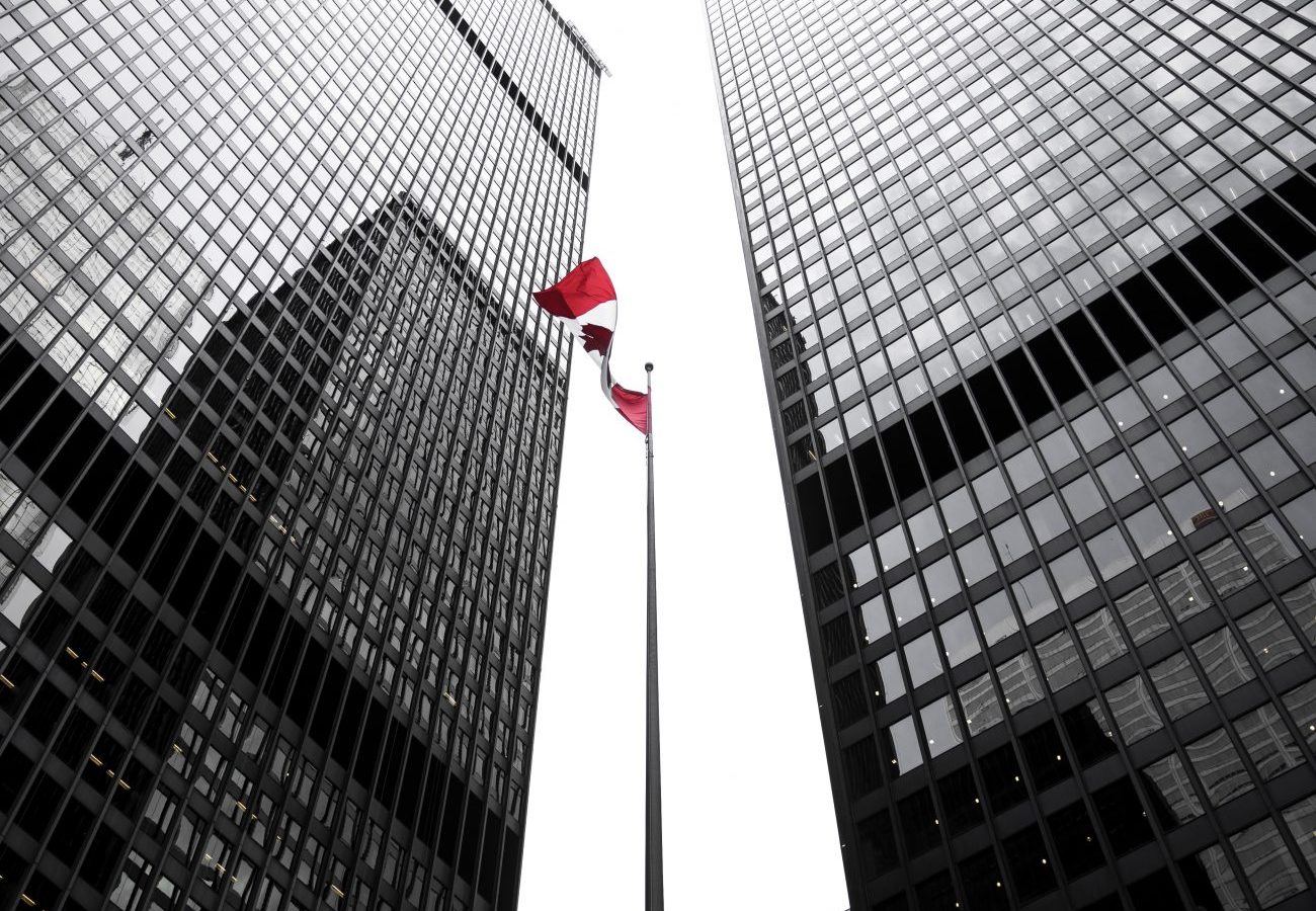 Two Toronto office tower skyscrapers with Canadian flag in the middle