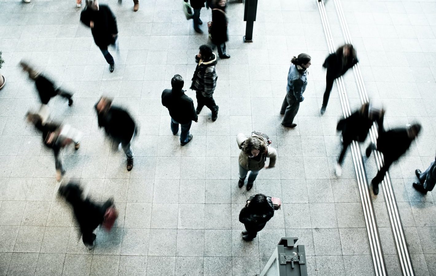 Aerial view of people walking across a paved area