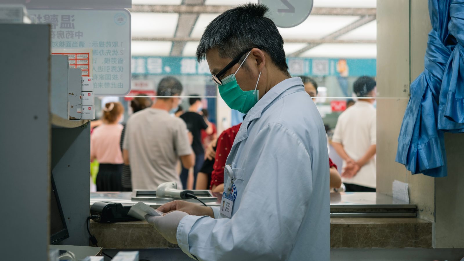 Pharmacist in mask prepares prescription