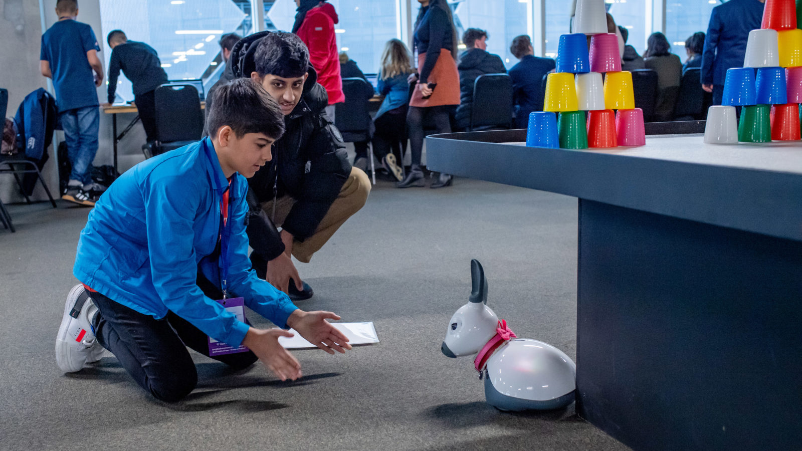 Two boys experiment with a robot animal
