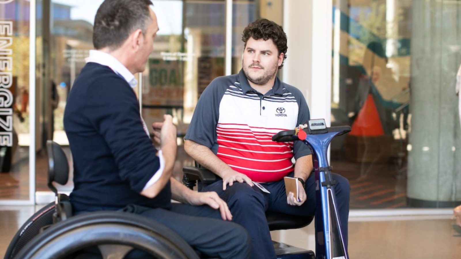 Wheelchair and mobility scooter users chatting