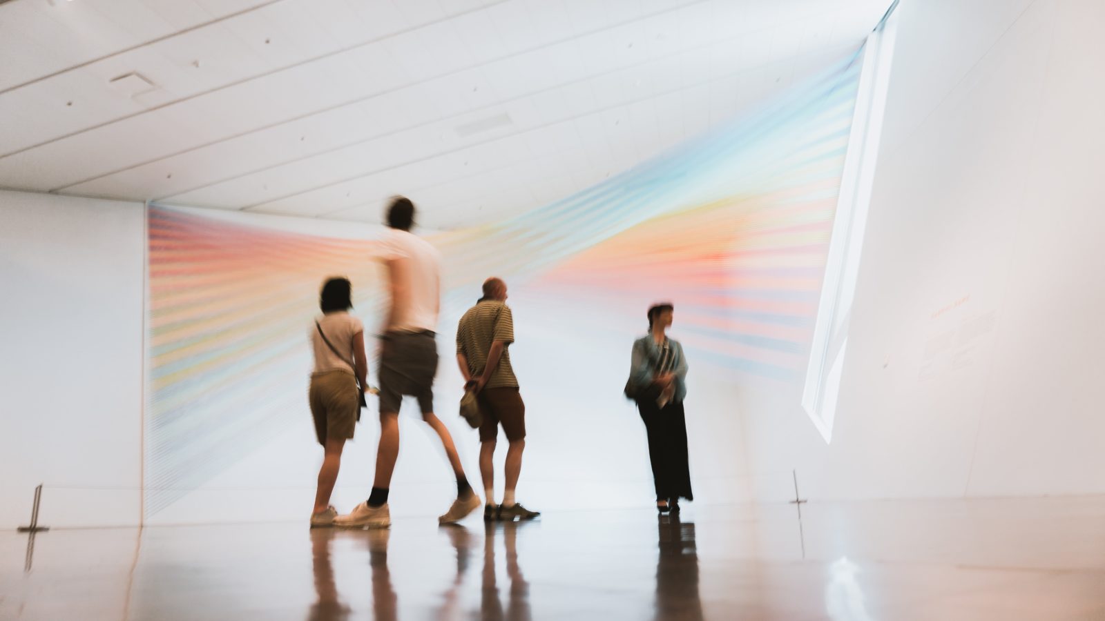 A group of people enjoy some artwork by Gabriel Dawe