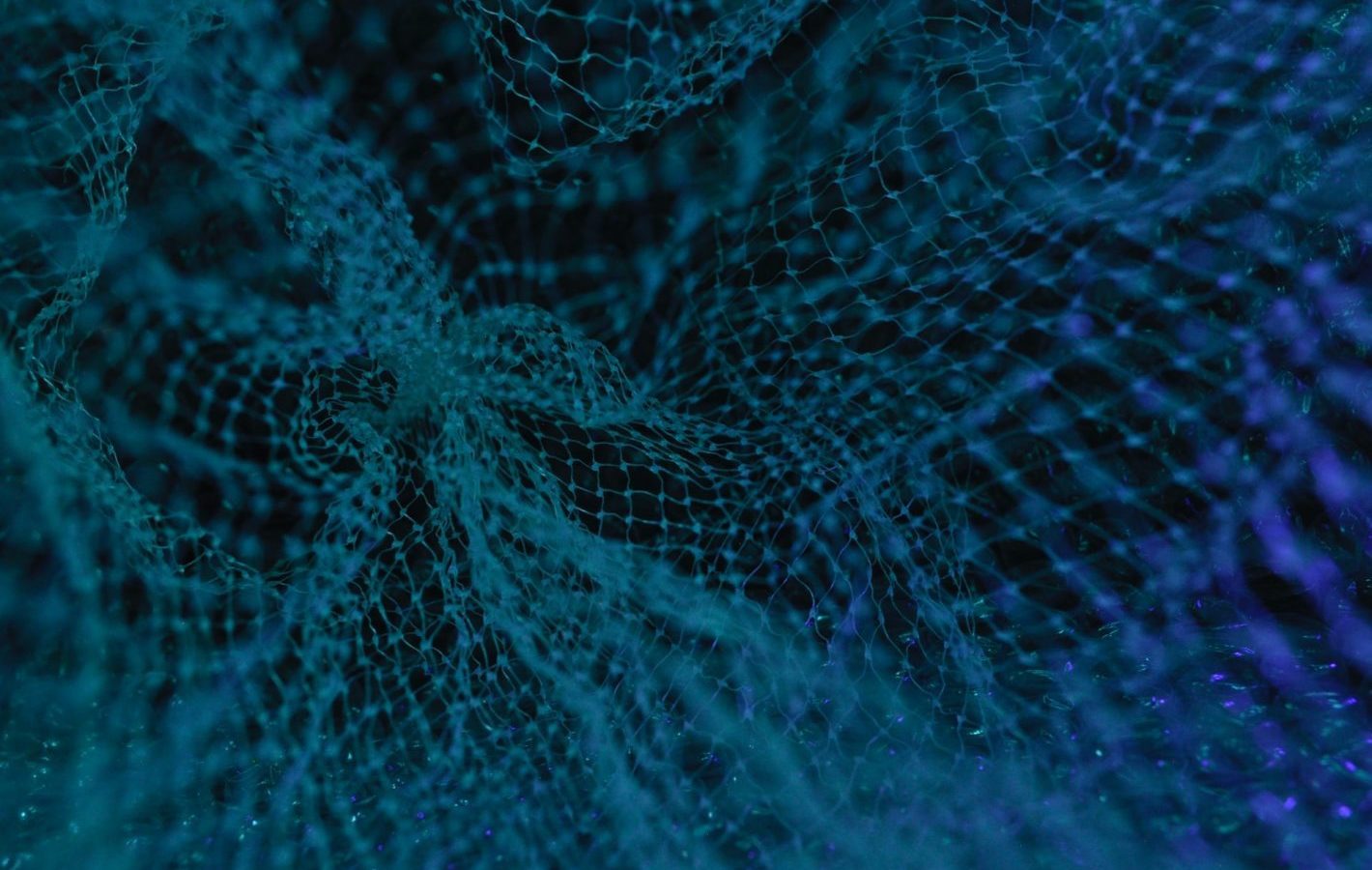 An extreme close up of some blue plastic mesh