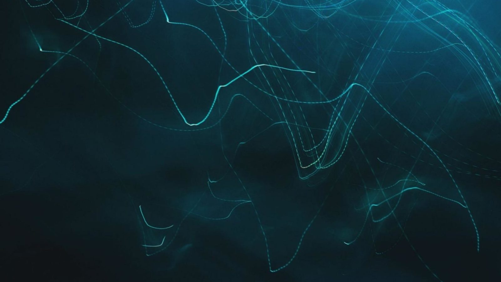 light trails through green and blue smoke