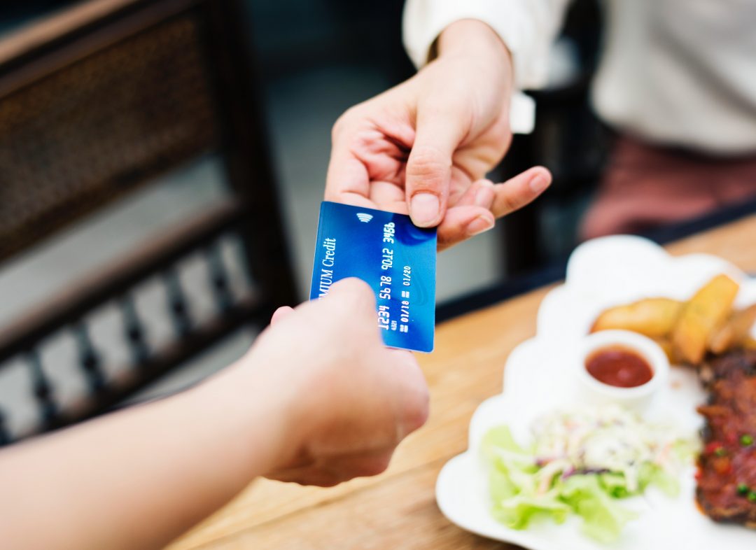 Hand offering a debit card