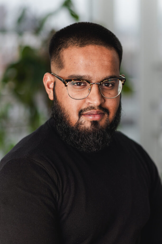 Photo of a young Asian man with glasses and facial hair