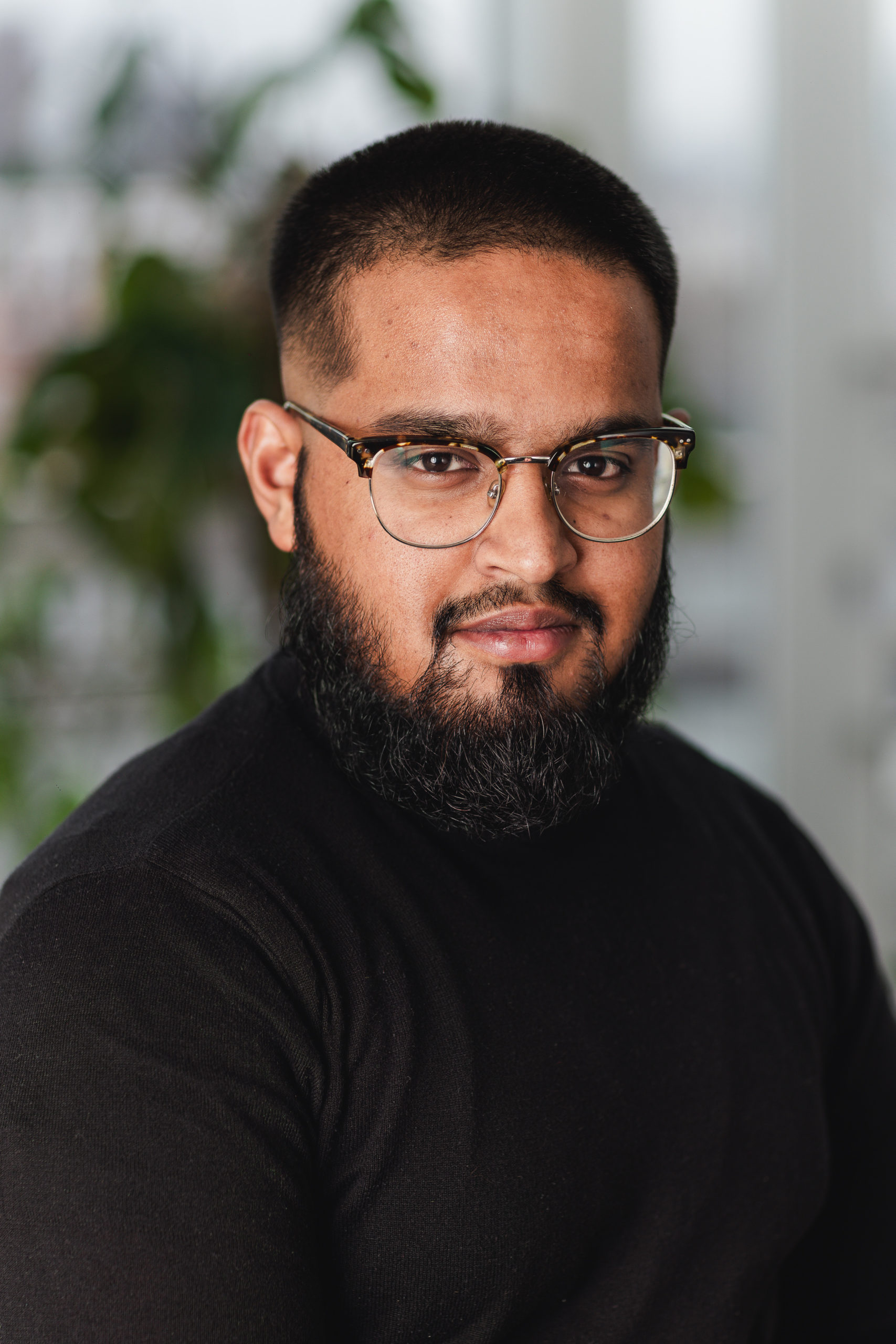 Photo of a young Asian man with glasses and facial hair