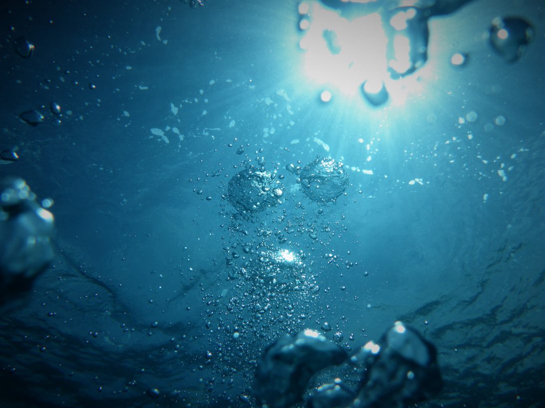 light reflecting on bubbles under the surface of water