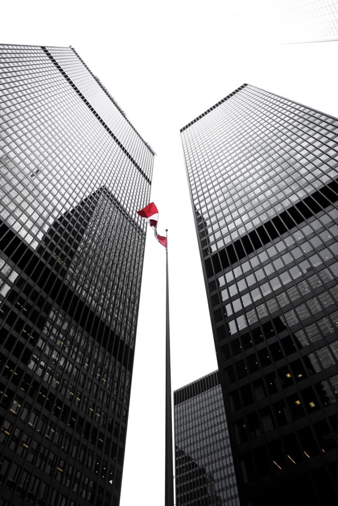 Two Toronto office tower skyscrapers with Canadian flag in the middle