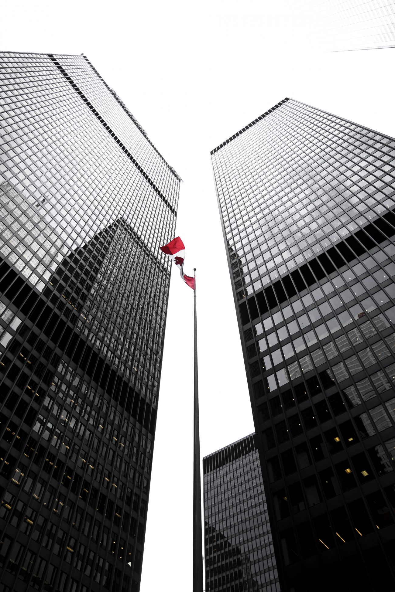 Two Toronto office tower skyscrapers with Canadian flag in the middle