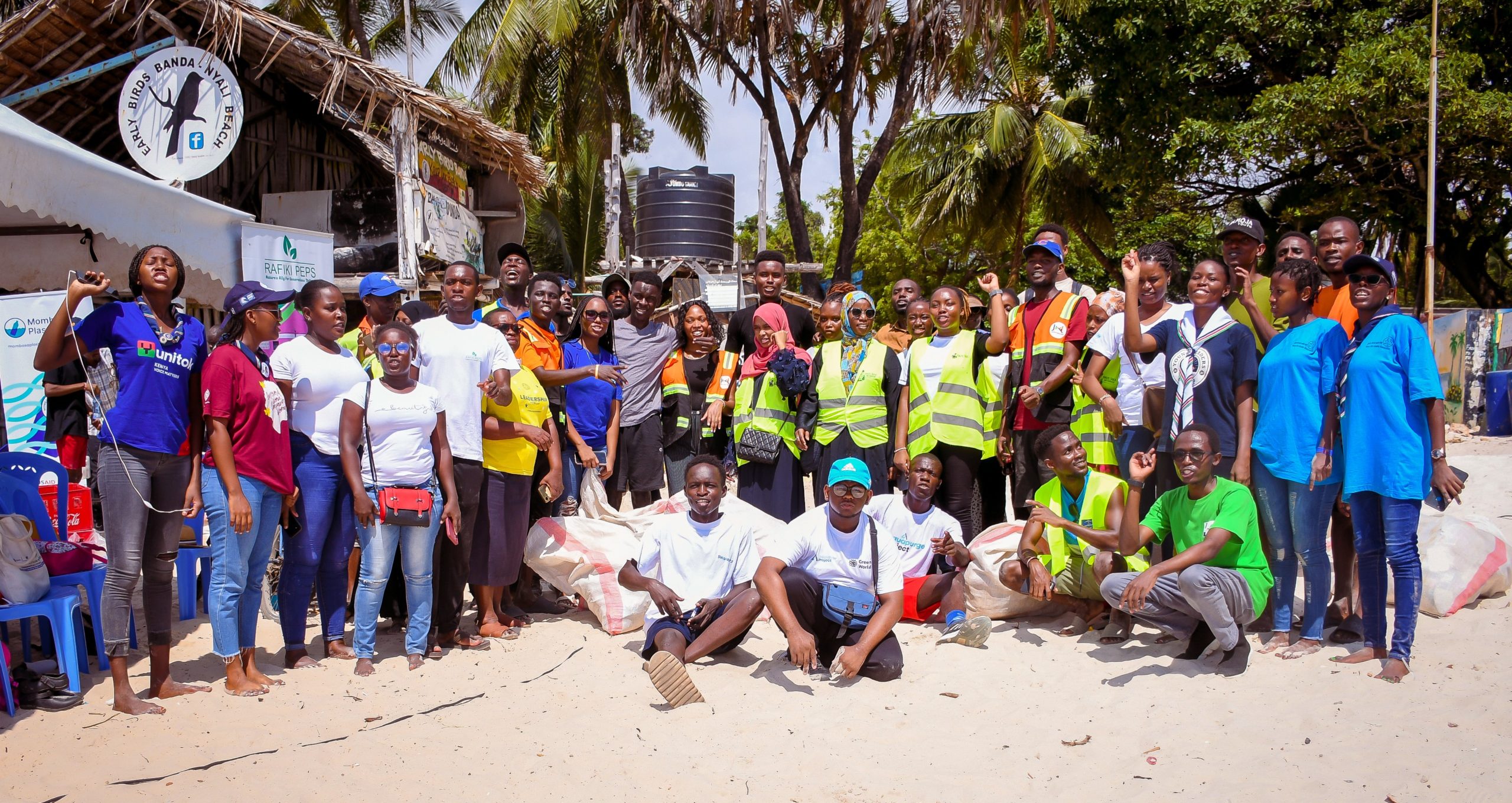 Group of people posing on a beach|Participants in Mombasa Plastic Prize on beach together|Twende Green Ecocycle|Plastic Taka Creatives|Capapo Solutions|Eco-Prints Generation|Rafiki Peps|Oceania Pacesetter|Clean Tech Collectors|Plas-Tech|Celebration of the Mombasa Plastic Prize Incubator teams on Earth Day.