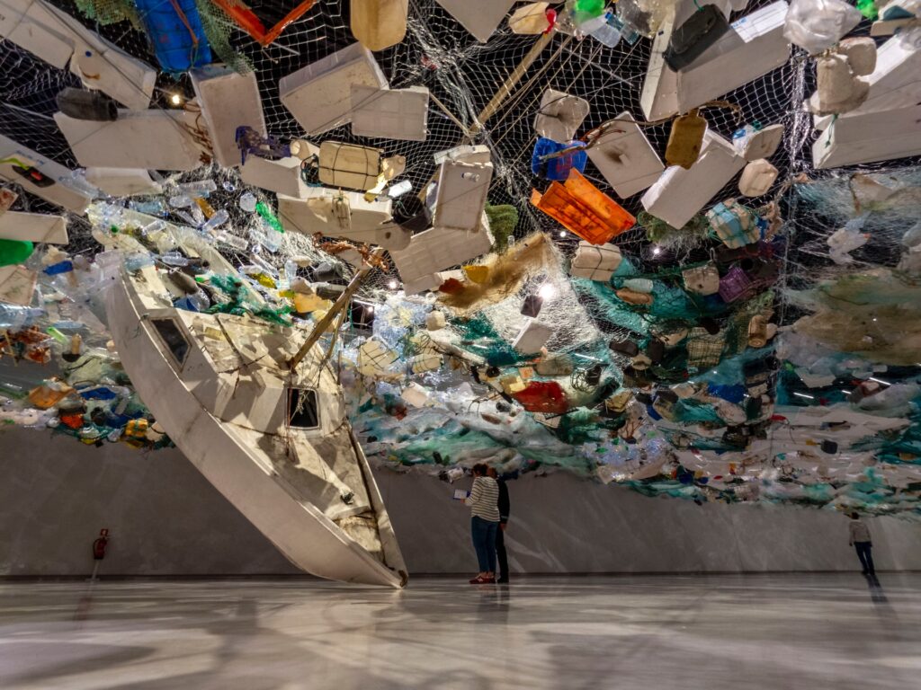 A display in an art gallery comprising hundreds of pieces of plastic garbage