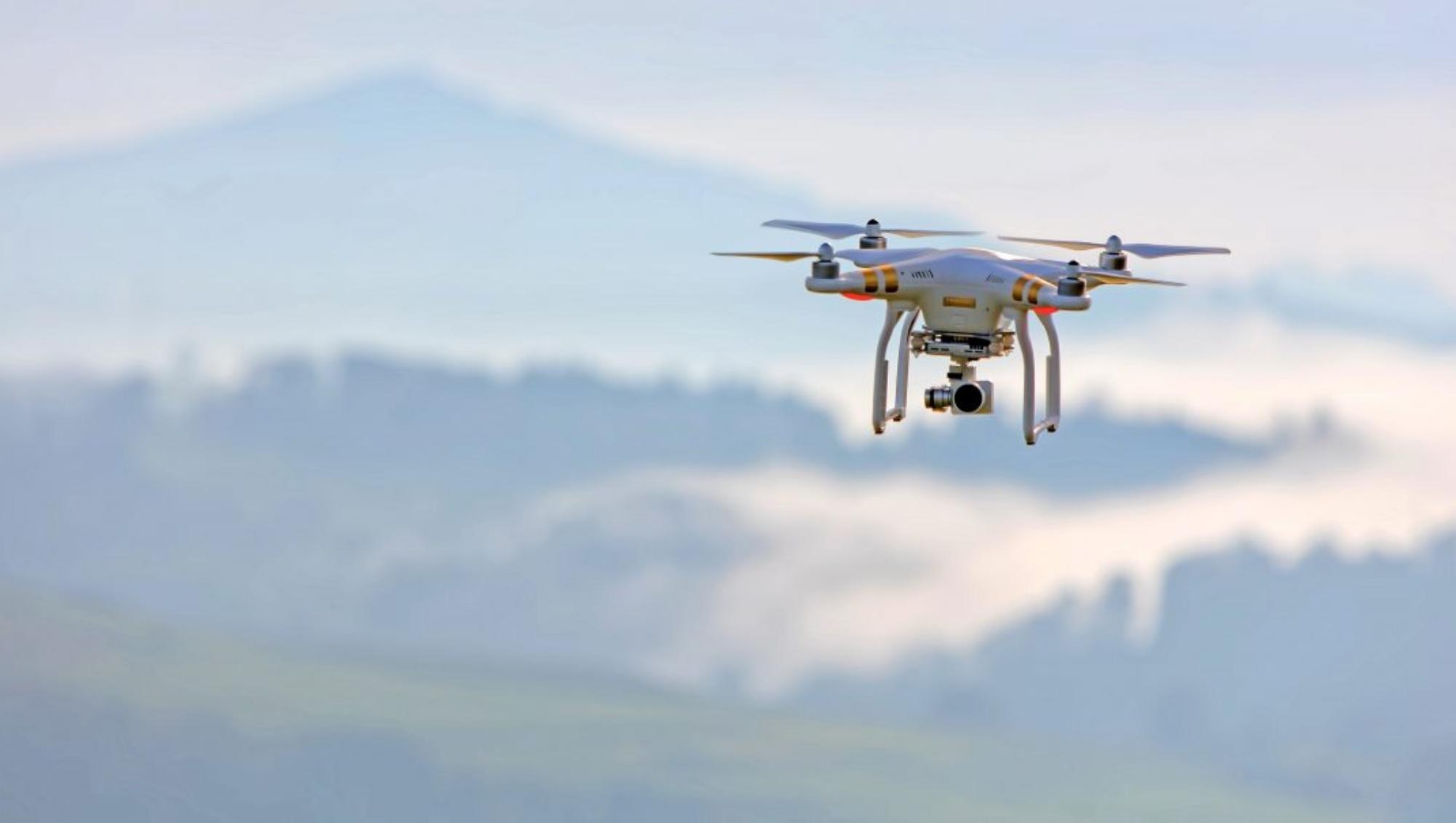 Drone in a bright sky|Industrial Strategy logo - UK Research and Innovation|Industrial Strategy logo