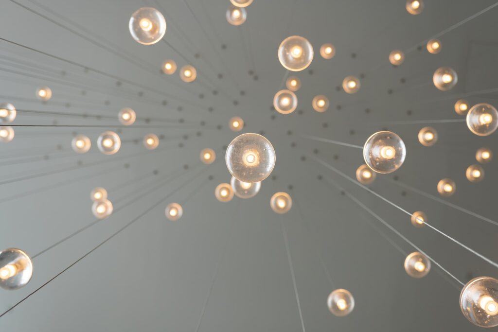 A shot looking up at a number of lightbulbs hanging from the ceiling. Because of the angle