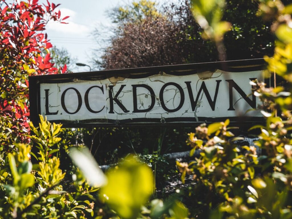 Lockdown street sign in a hedgerow|Lockdown street sign in a hedgerow|Let's talk loneliness. Oliver Dowden CBE