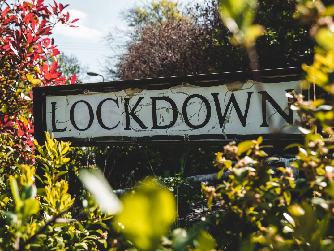 Lockdown street sign in a hedgerow|Lockdown street sign in a hedgerow|Let's talk loneliness. Oliver Dowden CBE
