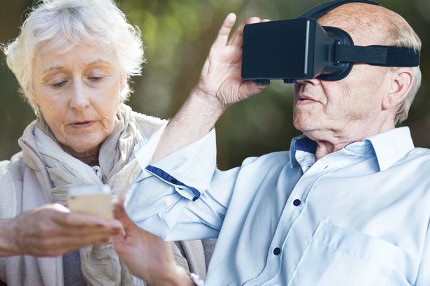 Elderly people using tech|A smiling older woman sat in a chair