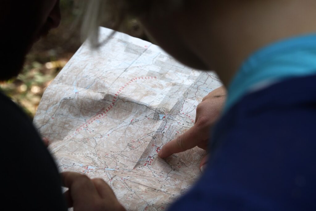 Looking over the shoulders of two people examining a map
