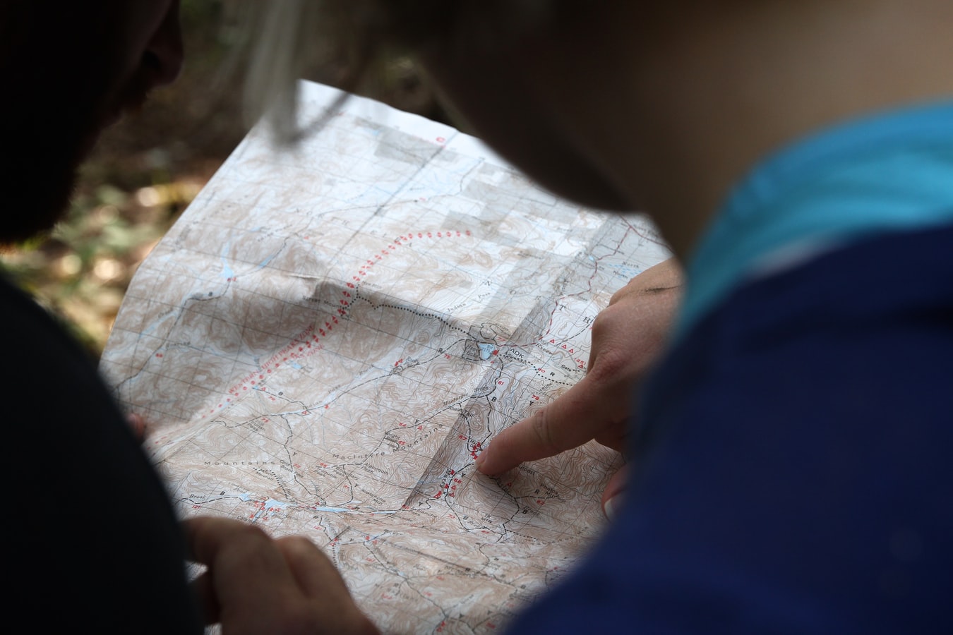 Looking over the shoulders of two people examining a map