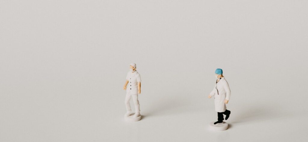 Two models of medical personnel are set against a white background