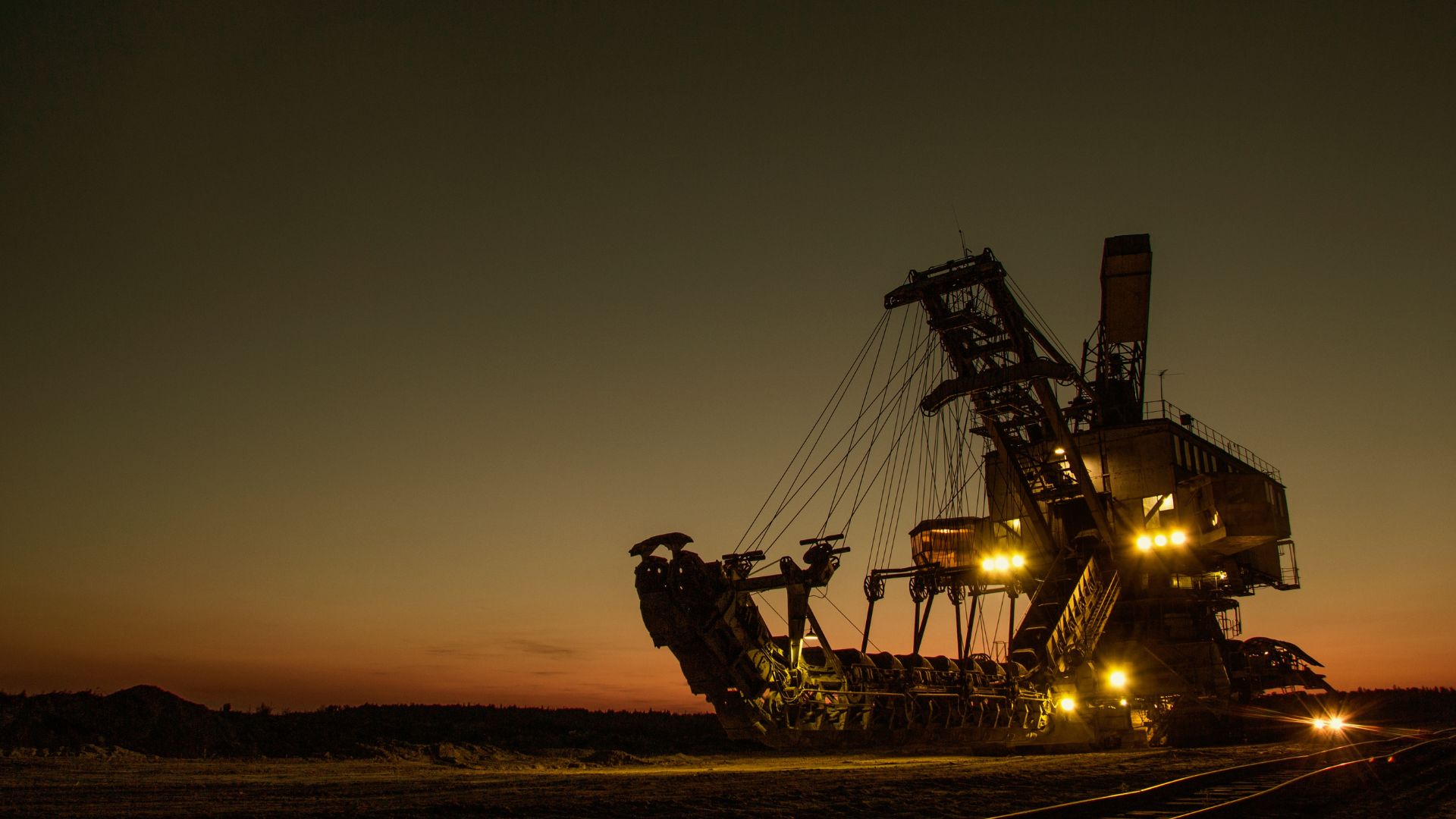 Image of a mining truck at dusk time|Black and white rocks