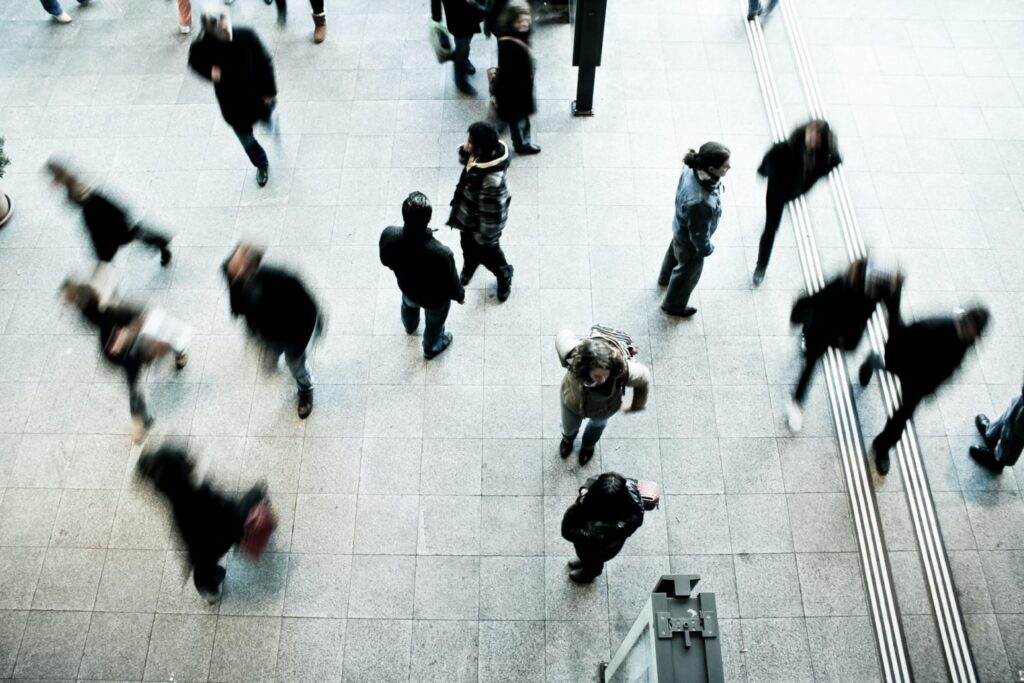Aerial view of people walking across a paved area