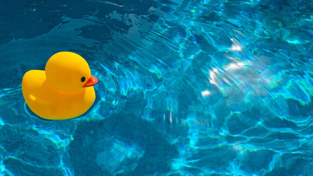 Rubber duck making little ripples in fresh clean water|Water Discovery Challenge logo on splash