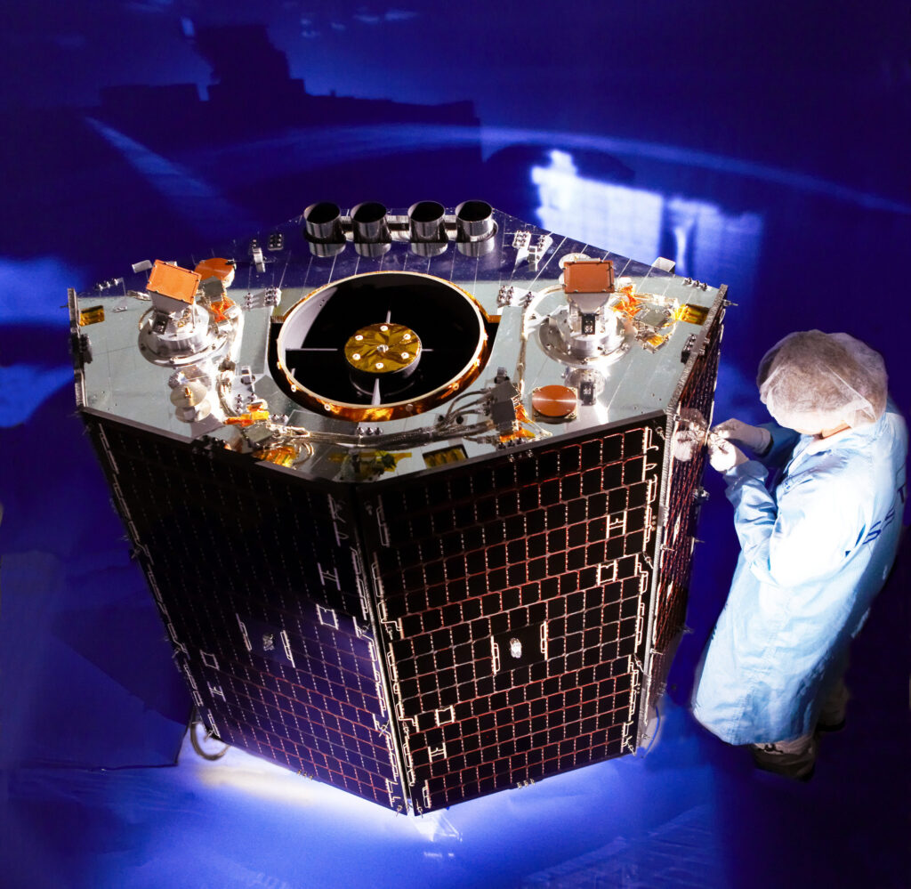 A member of staff at Surrey Satellite Technology works on a satellite at the company's Surrey Research Park base