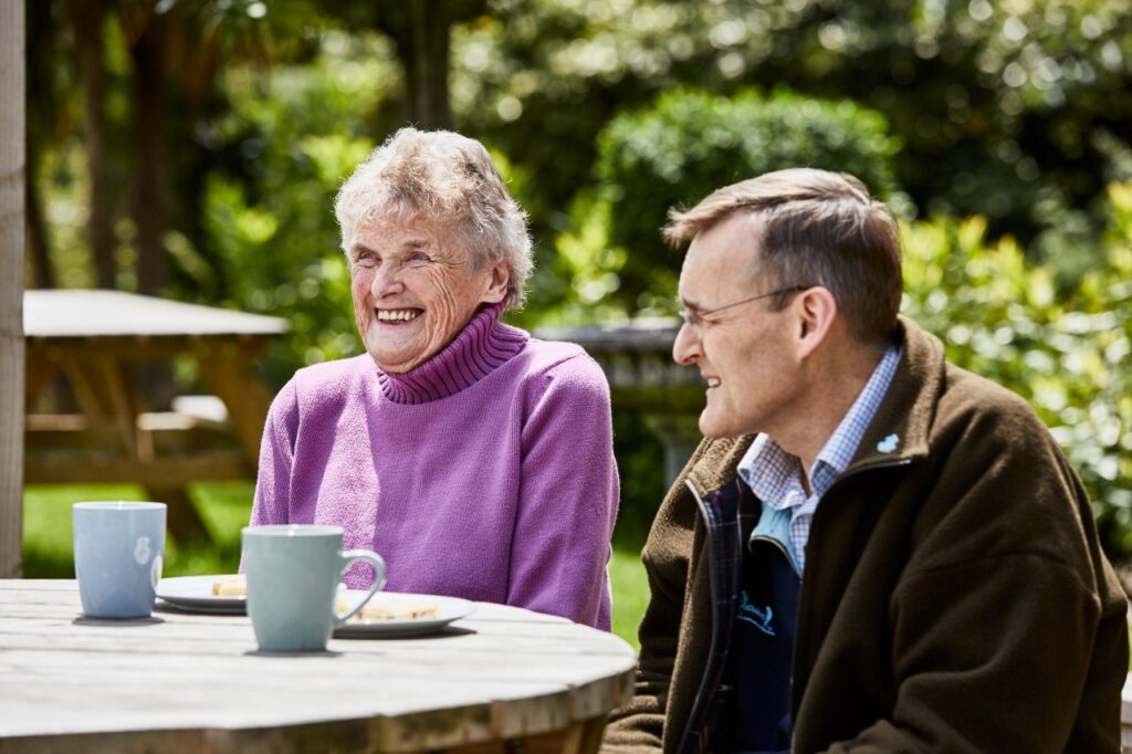 Elderly woman and man enjoying a cup of tea