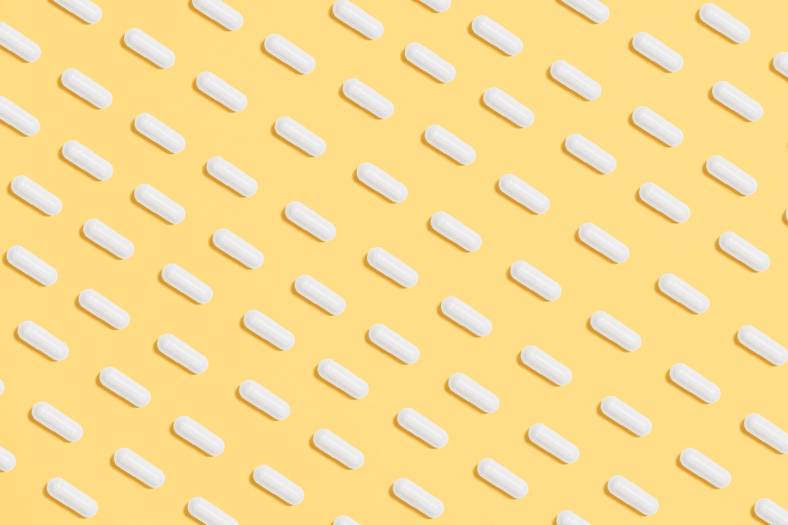 White pills across a yellow background|A Series One box. The text reads More Data. more analysis. More lives saced.