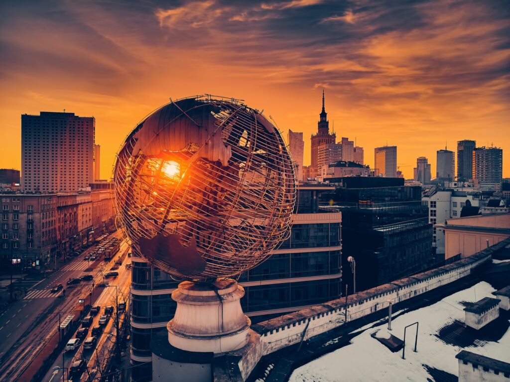 Globe statue against a city backdrop