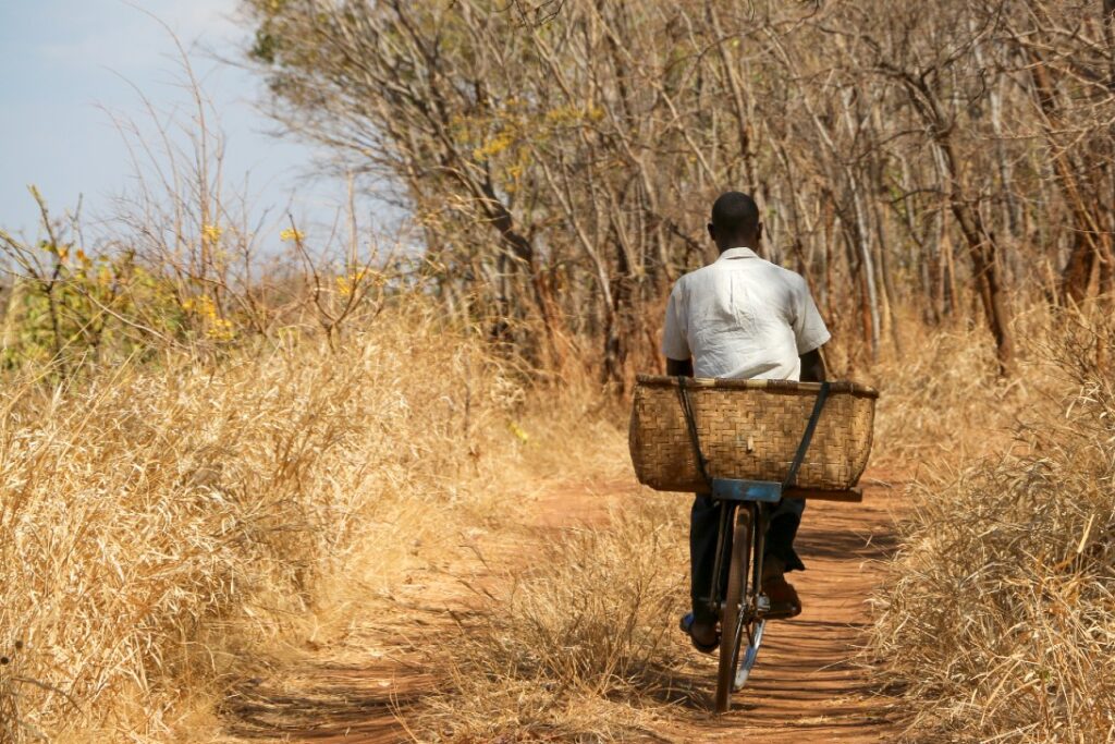 Man on bike in Africa|Family on bike in Africa