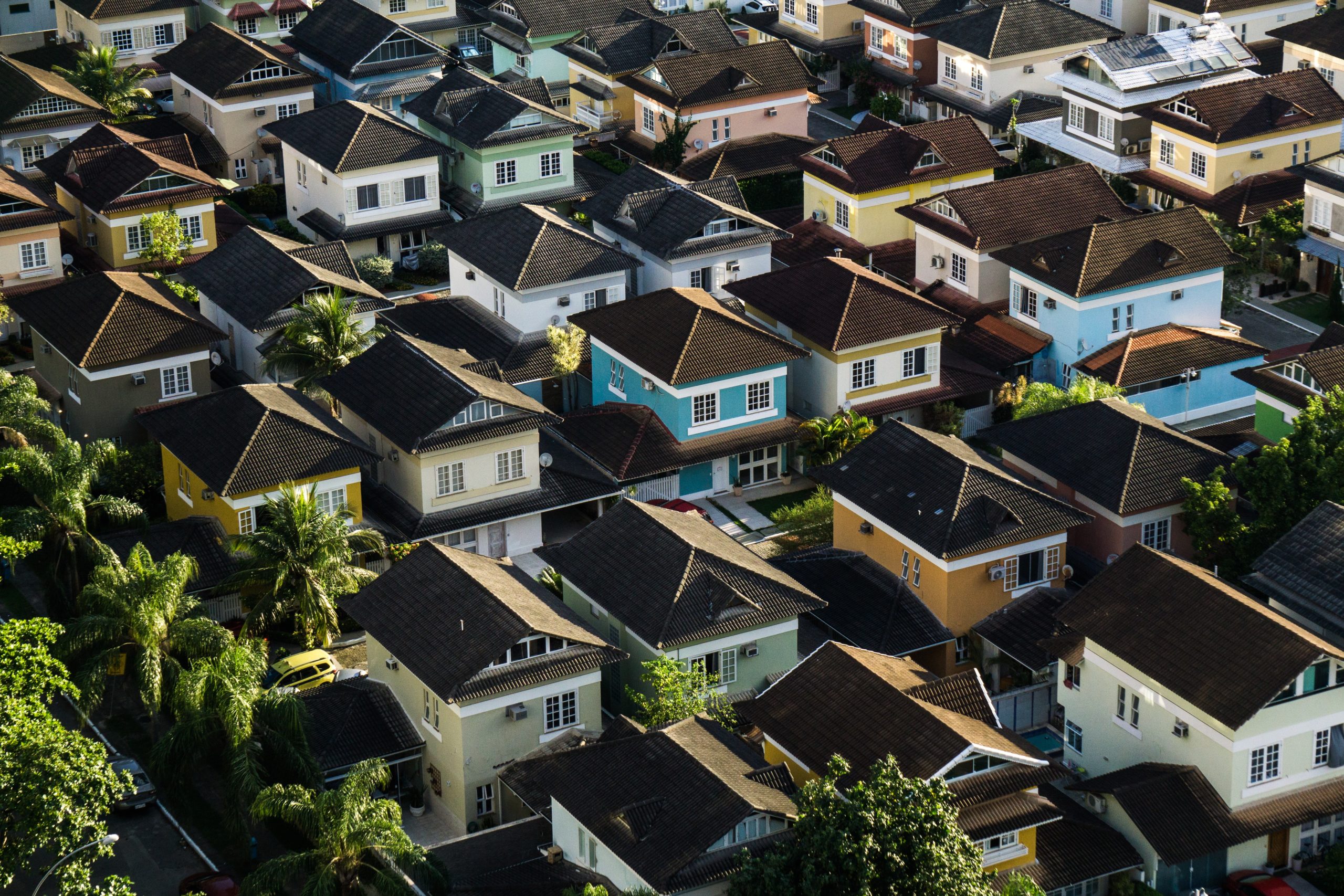An aerial view of houses|Apartment building with sun on the left