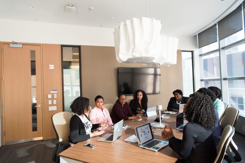A group of African women sitting around a table