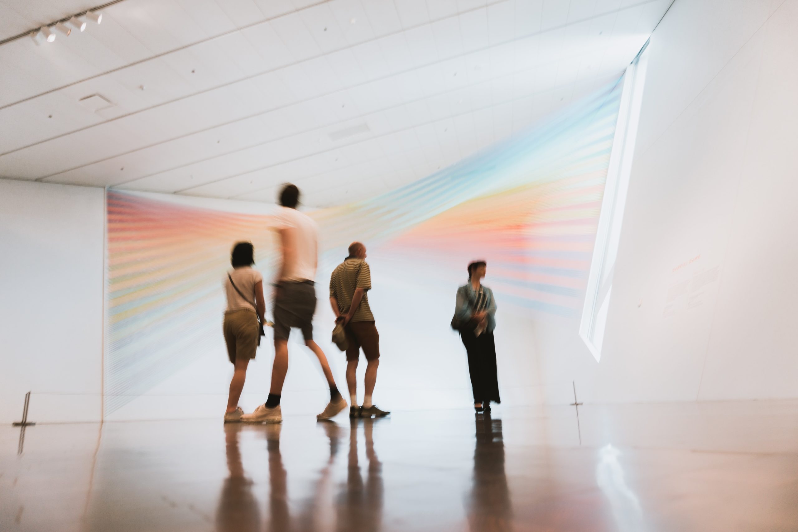 A group of people enjoy some artwork by Gabriel Dawe|Stage set of abstract illuminated cubes|Innovate UK logo