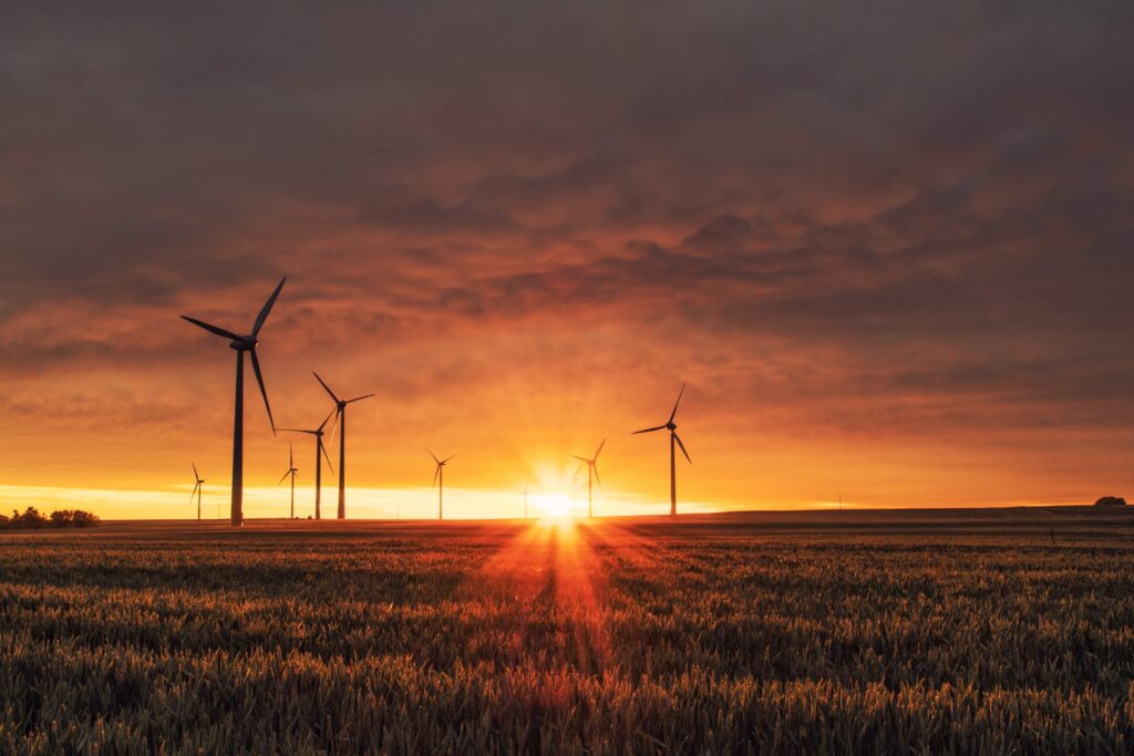 A landscape of windmills|Solar panels on grass