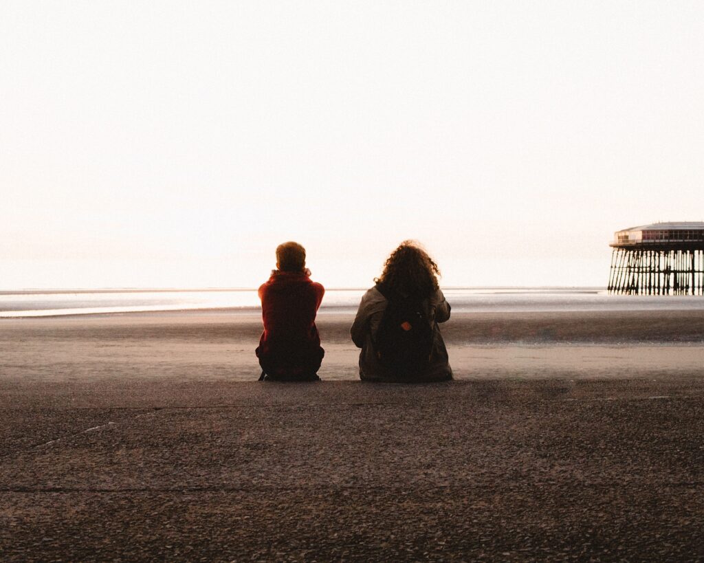 Two people sitting on a beach|Talk for Health logo|Lord Mayor's Appeal logo|PSYT app screenshot|The Money and Mental Health Policy Institute logo|Thrive logo