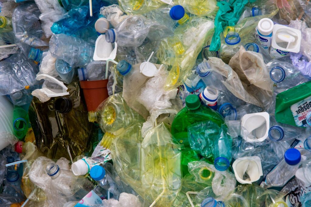 Colourful crunched up plastic bottles await recycling|An illustration of the Plastic Value Chain