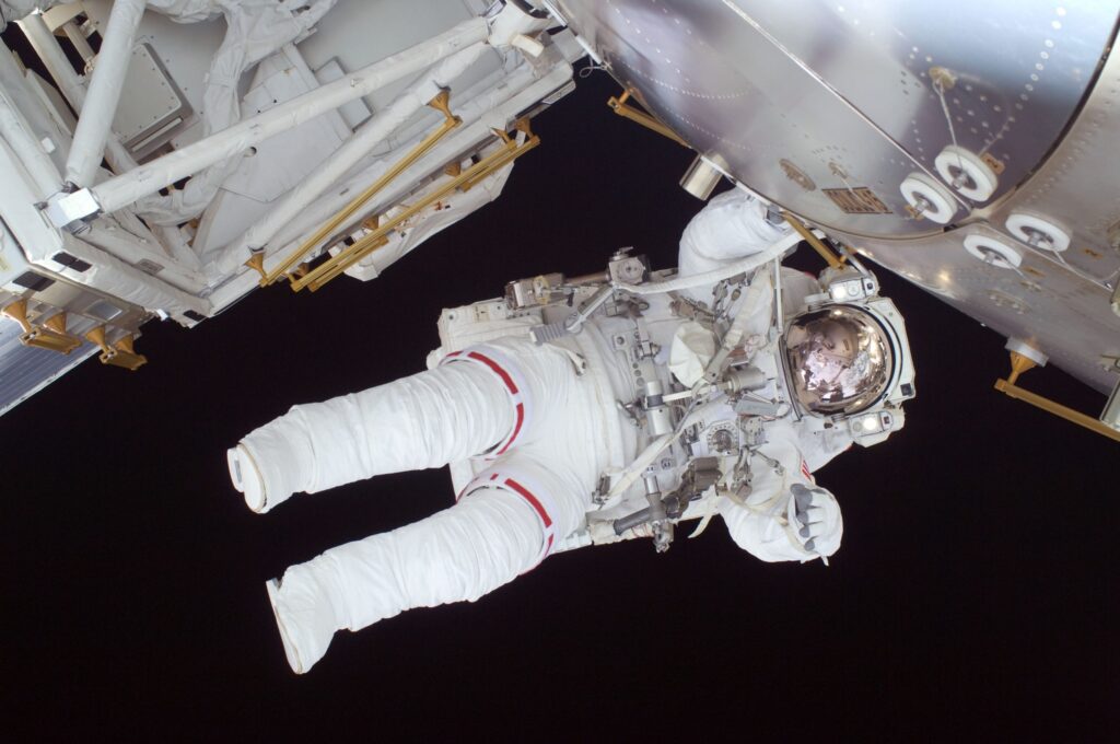 An astraunaut in flight at a space station
