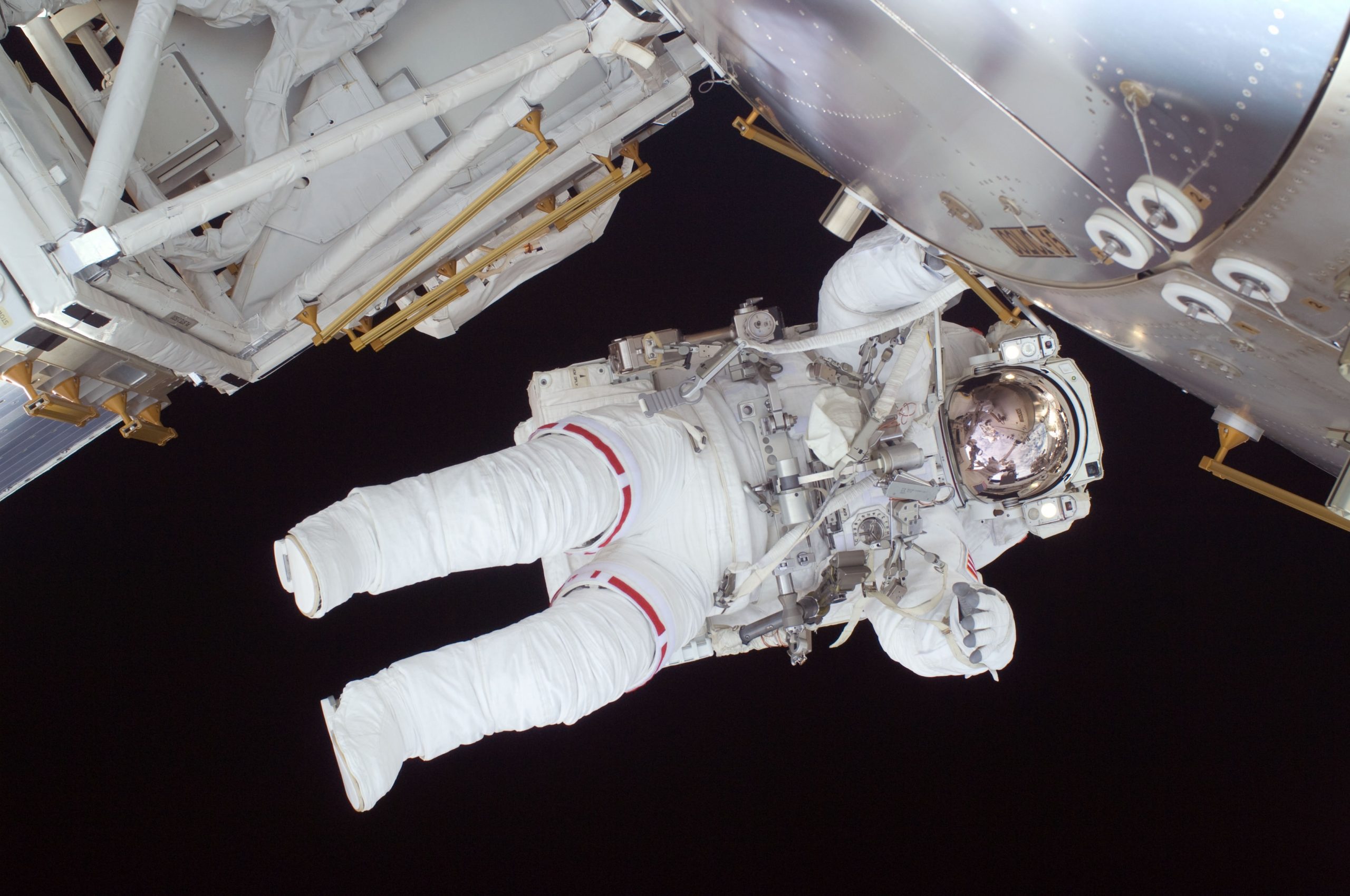 An astraunaut in flight at a space station