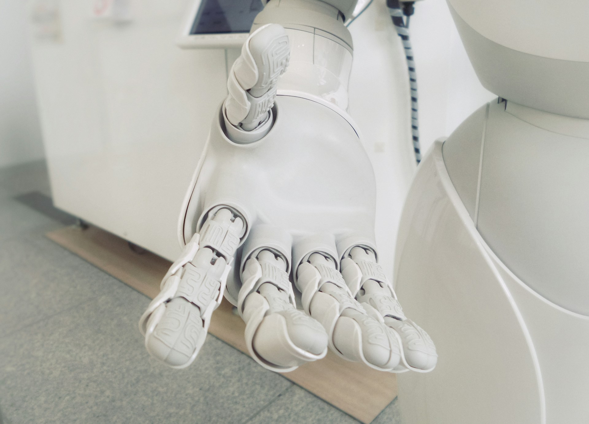 closeup photo of white robot hand