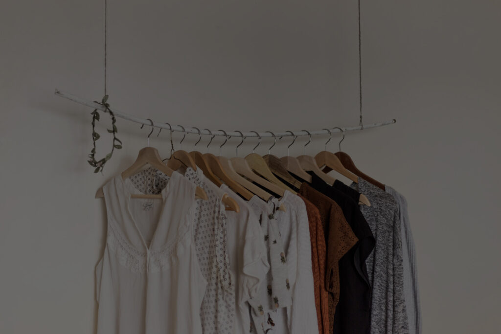 A silver rail of neutral coloured clothes