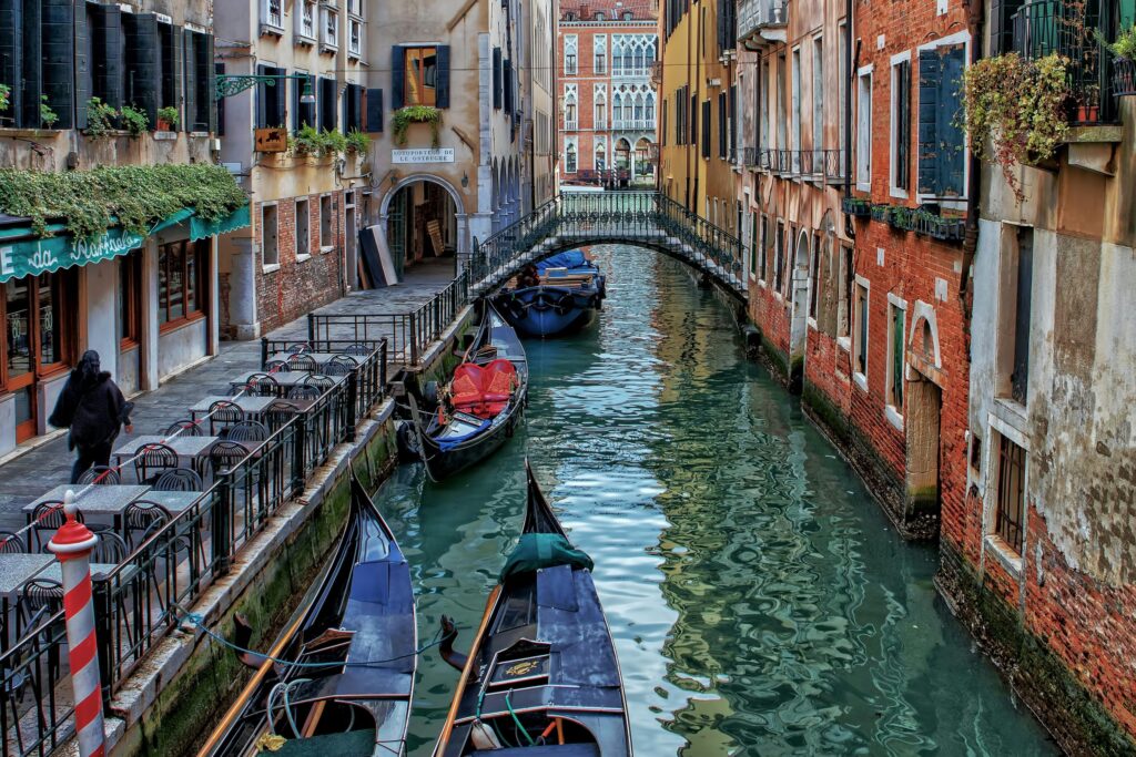 canal in Venice.|Image of Nassin (Challenge Works programme manager) presenting in Venice.|Image of Nassin Watson