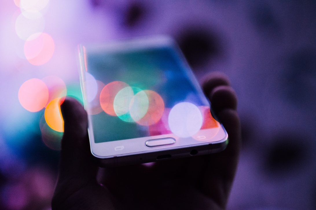 Hand holding a mobile phone|Department for Digital