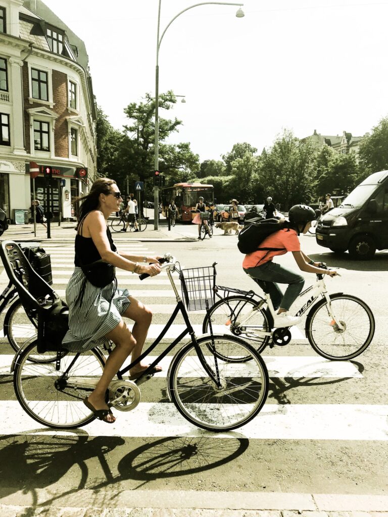 Image of two people cycling through a road|A man cycling|Image of a crowd of people cycling in numerous directions