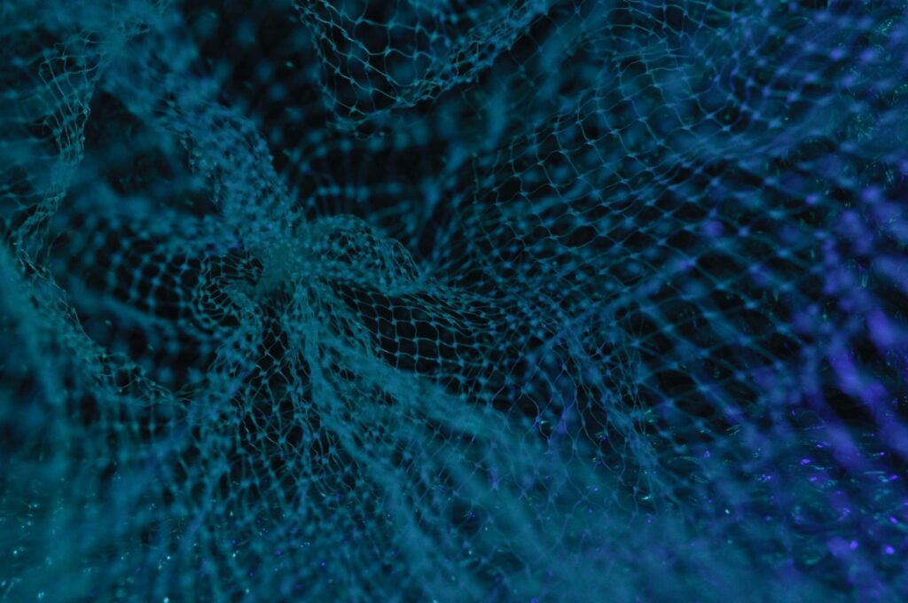 An extreme close up of some blue plastic mesh