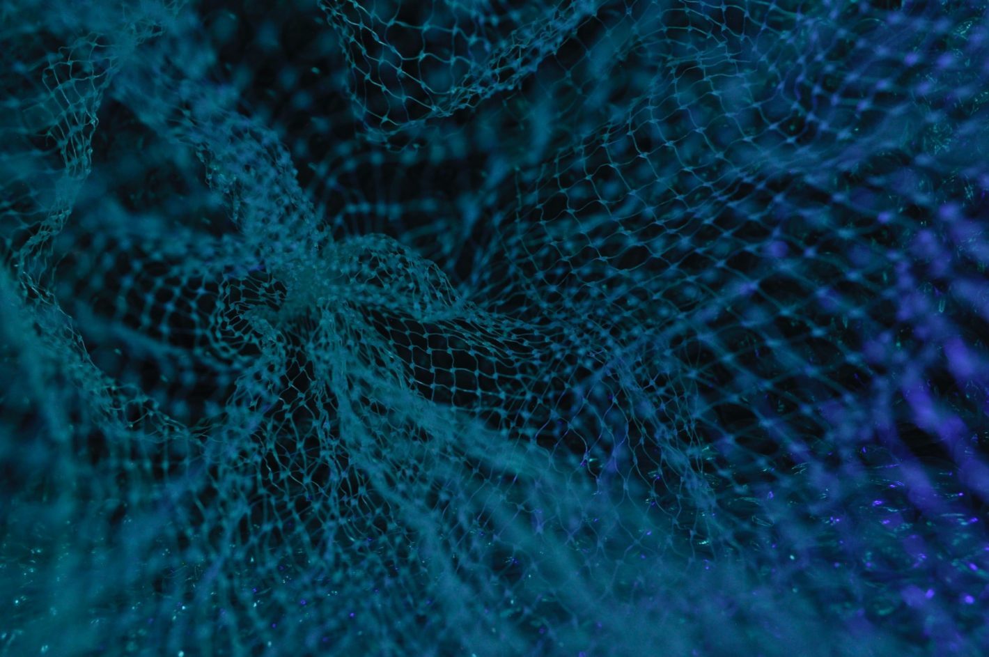 An extreme close up of some blue plastic mesh