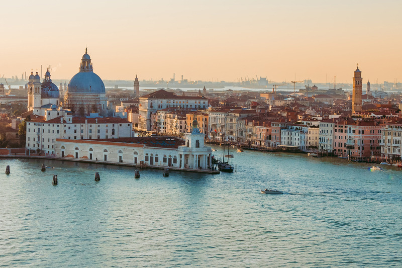 view over the water of the city of venice during sunset